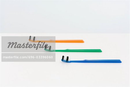 Three toothbrushes, staggered and colorful