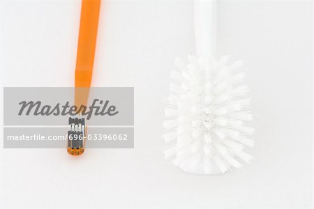 Toothbrush and cleaning brush side by side