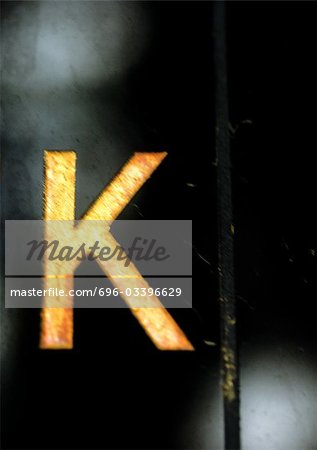 K, text, painted, blurry. K, text, painted, blurry.