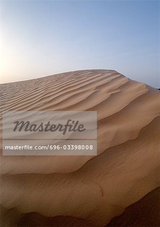 Tunisia, Sahara,  rippled sand dune against sky