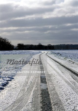 France, Picardy, road through fields with snow