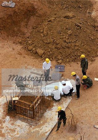 People wearing hard hats on construction site, elevated view