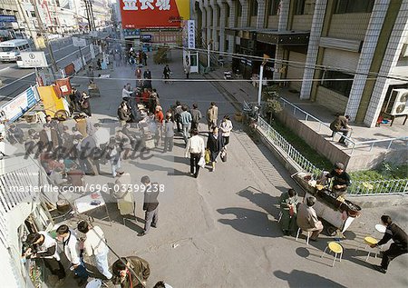 China, Xinjiang, Urumqi, street vendors,customers, pedestrians, high angle view