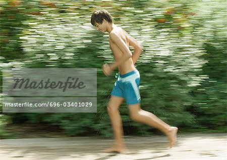 Boy in swimming trunks running - Stock Photo - Masterfile - Premium Royalty- Free, Code: 696-03401029