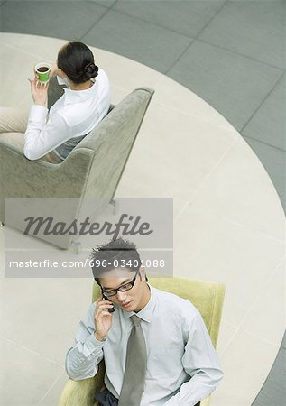 Executive using cell phone in lobby