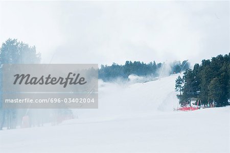 Ski slopes, artificial snow being sprayed