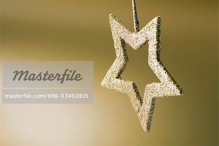 Golden star shaped Christmas tree ornament, upside down