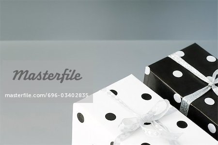 Two black and white polka dotted gift wrapped presents