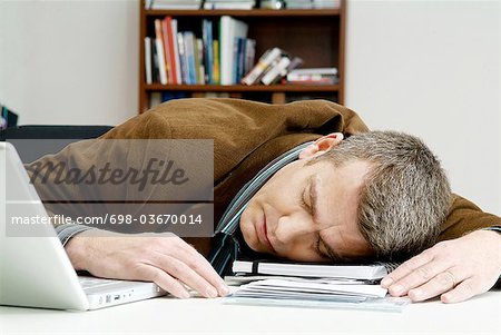 Man Has Fallen Asleep On The Desk Stock Photo Masterfile