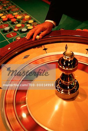 Man's Hand and Roulette Wheel