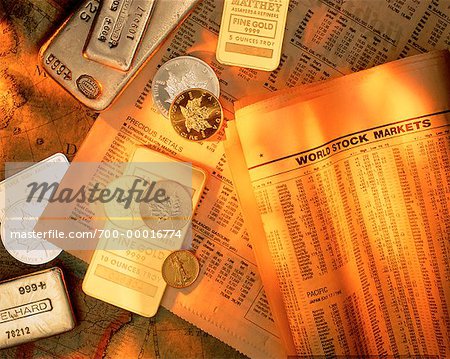 Gold Ingots and Coins with Financial Pages on Antique World Map