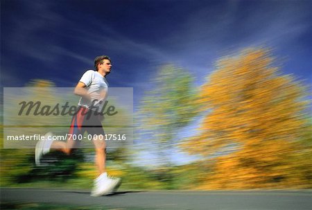 Blurred View of Man Running Outdoors in Autumn