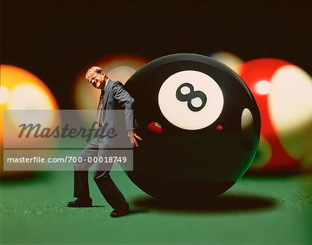 Businessman Struggling to Move Giant Eight Ball