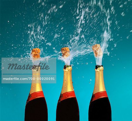 Corks Popping from Champagne Bottles - Stock Photo - Masterfile