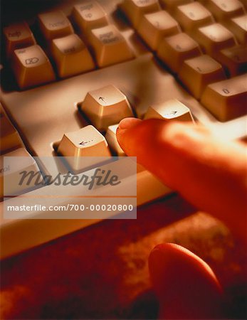 Close-Up of Hand on Computer Keyboard