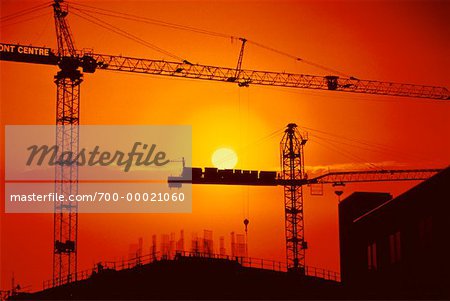 Silhouette of Construction Cranes At Sunset