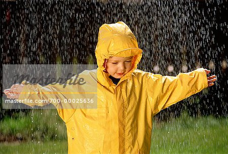 Premium Photo  Boy wearing yellow raincoat feeling surprised