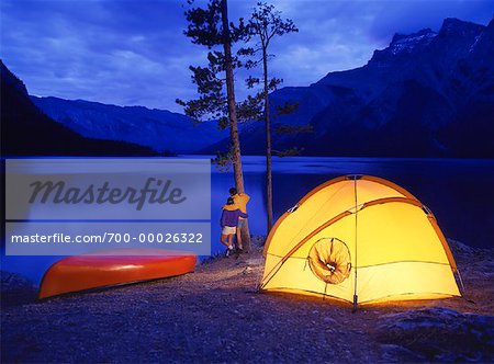 Couple at Campsite at Dusk Lake Minnewanka, Banff National Park, Alberta, Canada