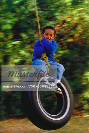 Portrait of Boy on Tire Swing