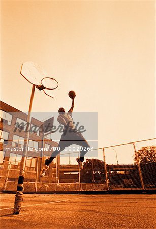 Man Playing Basketball Outdoors