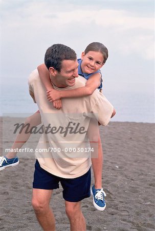 Father Holding Daughter at the Beach