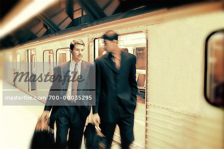 Businessmen Leaving Subway Train