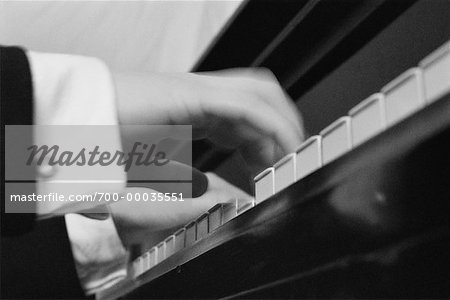 Close-Up of Hands Playing Piano