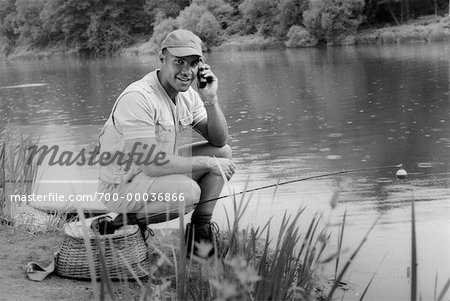 Man Fishing, Using Cell Phone