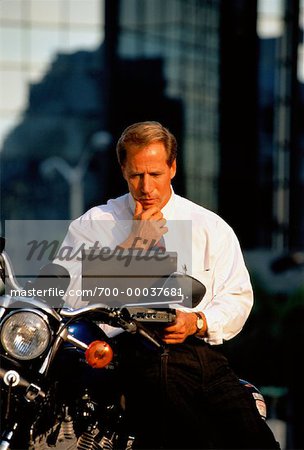 Businessman Using Laptop Computer On Motorcycle