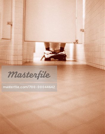 https://image1.masterfile.com/getImage/700-00044642em-businessman-in-washroom-stall-stock-photo.jpg