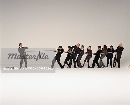 Businessman Having Tug Of War With Group Of Business People Stock Photo Masterfile Rights Managed Artist Masterfile Code 700