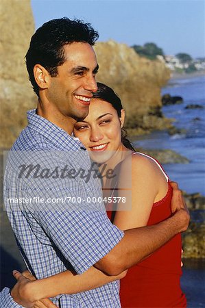 Portrait of Couple Embracing on Beach