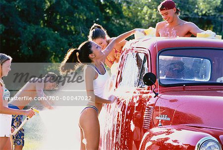 Group of Teenagers Washing Truck