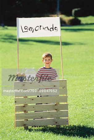 Boy with Lemonade Stand in Field