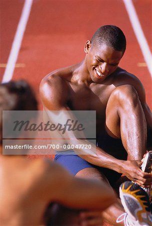 Men Stretching on Outdoor Track