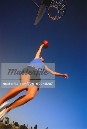 Woman Playing Basketball Outdoors