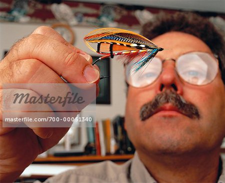 Male Flytier Tying Fishing Fly Under Magnifying Glass - Stock Photo -  Masterfile - Rights-Managed, Artist: Dan Lim, Code: 700-00051344