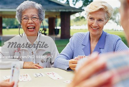 Mature Women Playing Cards in Park