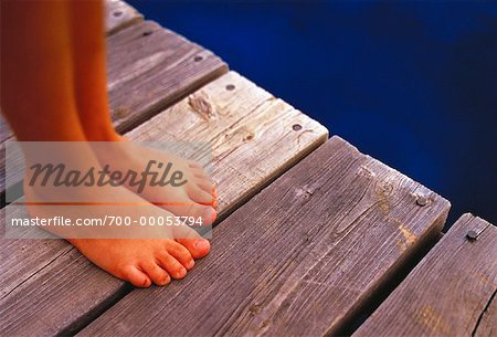 Close-Up of Child's Feet on Dock