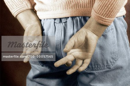 Close-Up of Child Crossing Fingers Behind Back
