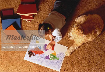 Overhead View of Girl Sitting on Floor Coloring Map with Dog