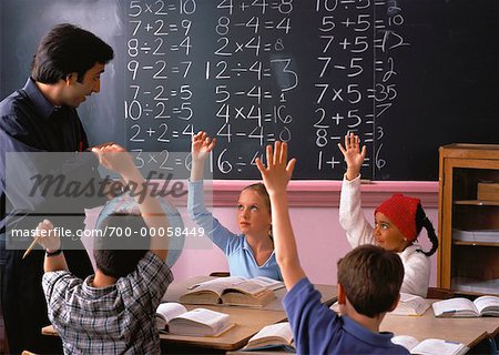 Children with Hands Raised in Classroom