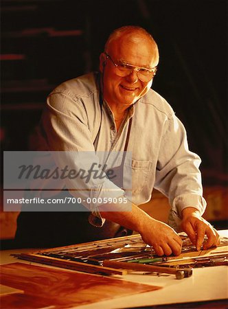 Portrait of Mature Male Stained Glass Artisan in Workshop