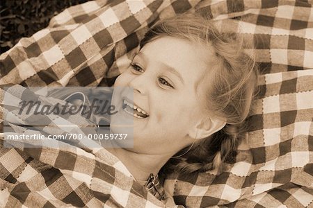 Girl Lying on Blanket Outdoors