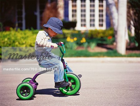 boy riding tricycle