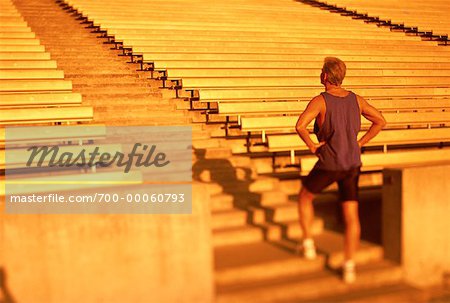 Back View of Mature Man Standing On Stadium Steps