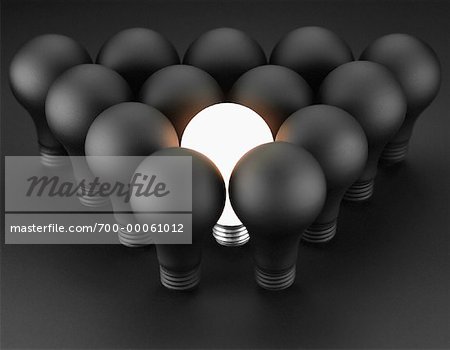 Single Glowing Lightbulb Surrounded by Lightbulbs