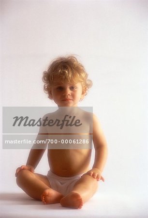 Portrait of Child Wearing Diaper Sitting on Floor