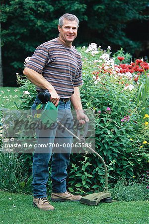 Portrait of Male Gardener near Flowers, Ontario, Canada - Stock
