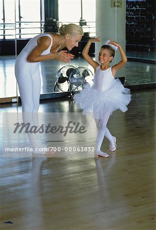 Mother with Daughter Wearing Ballerina Costume in Studio